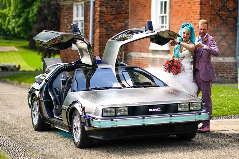 Rent the DeLorean Time Machine as a wedding car — bride and groom with the gull-wing doors raised